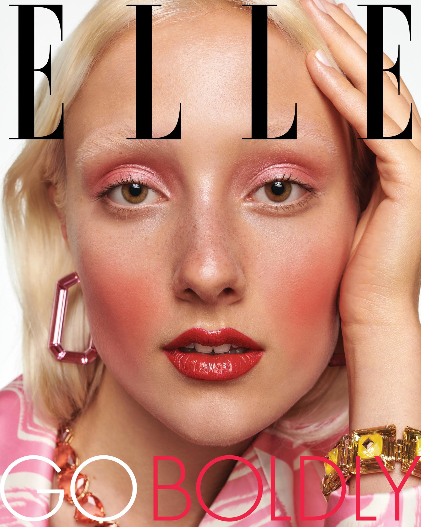 Elle magazine cover featuring a young woman with bleached blonde hair and red lipstick wearing statement jewelry, posing with a white background.